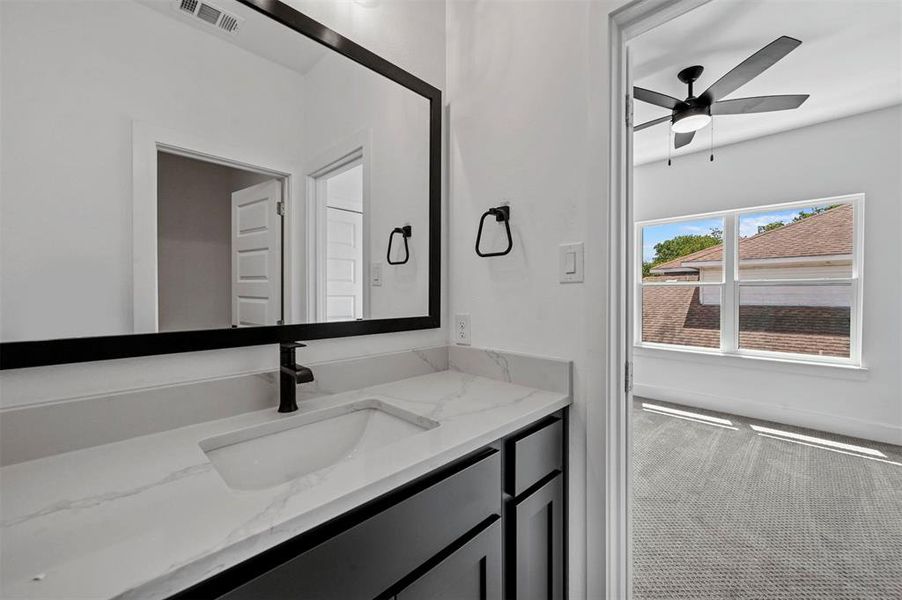 Bathroom with ceiling fan and vanity