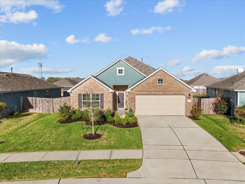 Front exterior of a new home in Mustang Crossing, Alvin, TX, highlighting curb appeal (Image 21).