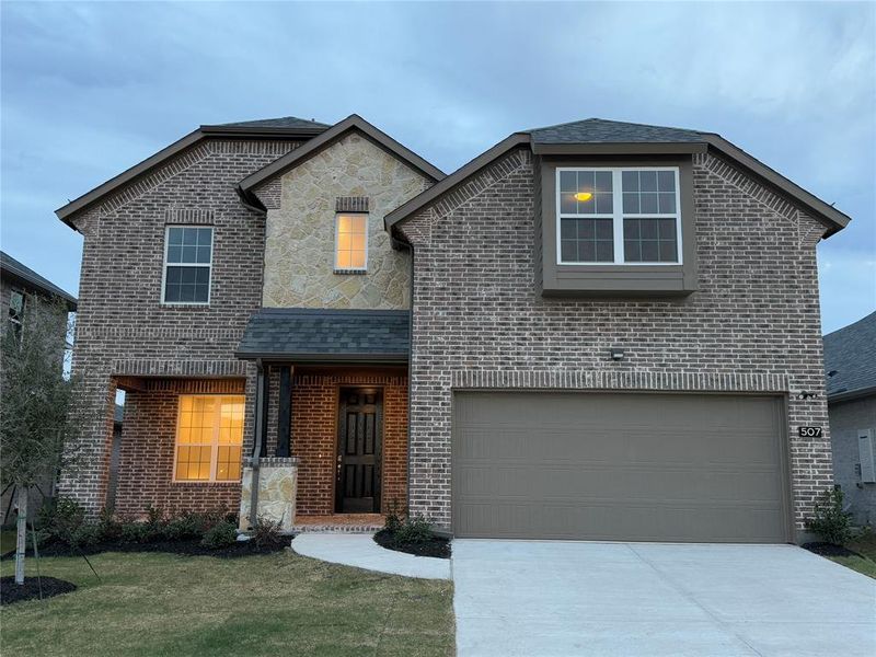 Front of property with a front lawn and a garage- Actual House