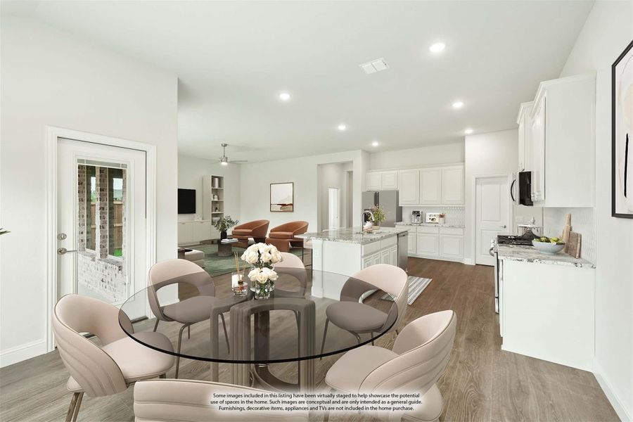 Open-concept dining area with glass round table, leading to white kitchen and living room with hardwood floors Open-concept dining area with glass round table, leading to white kitchen and living room with hardwood floors