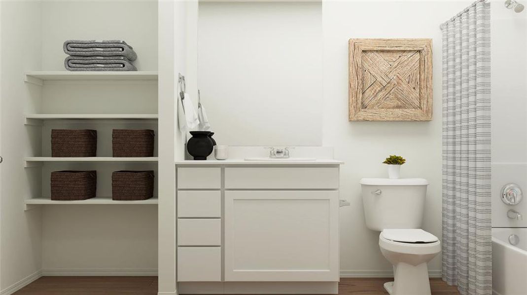 Full bathroom featuring shower / bathtub combination with curtain, hardwood / wood-style floors, vanity, and toilet