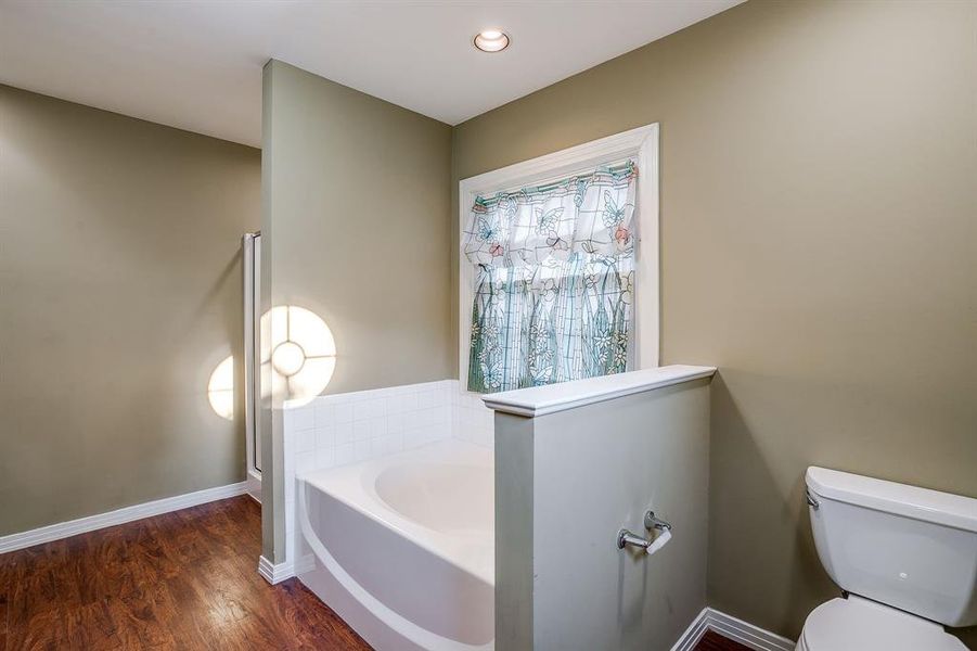 Soaking tub and a separate shower in the downstairs primary bathroom Soaking tub and a separate shower in the downstairs primary bathroom