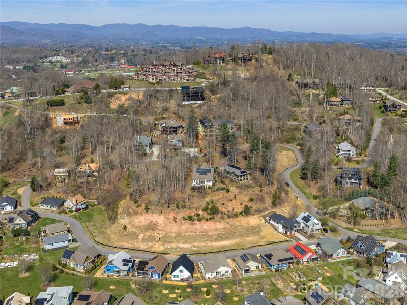 Aerial view of the Courtyard Villas community setting within The Villages at Crest Mountain, showcasing the surrounding neighborhood and mountain backdrop.