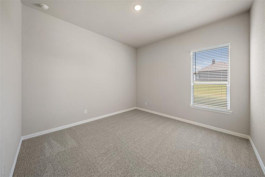 Carpeted spare room with baseboards Carpeted spare room with baseboards