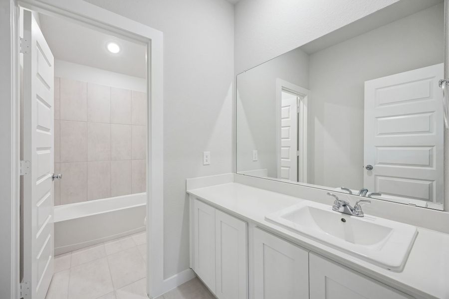 Bathroom in the Masters home plan by Trophy Signature Homes – REPRESENTATIVE PHOTO