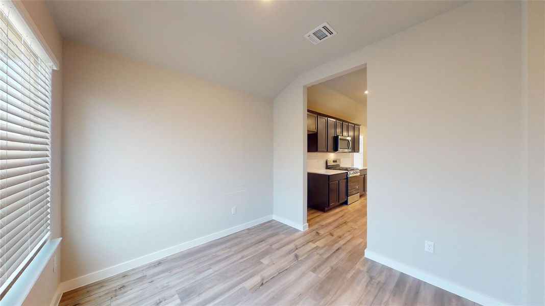 Flowing LVP flooring extends from the naturally illuminated living area into the functional kitchen. Flowing LVP flooring extends from the naturally illuminated living area into the functional kitchen.