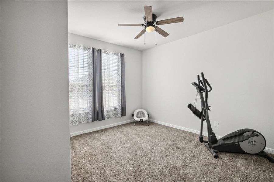 Workout room with ceiling fan and carpet floors Workout room with ceiling fan and carpet floors