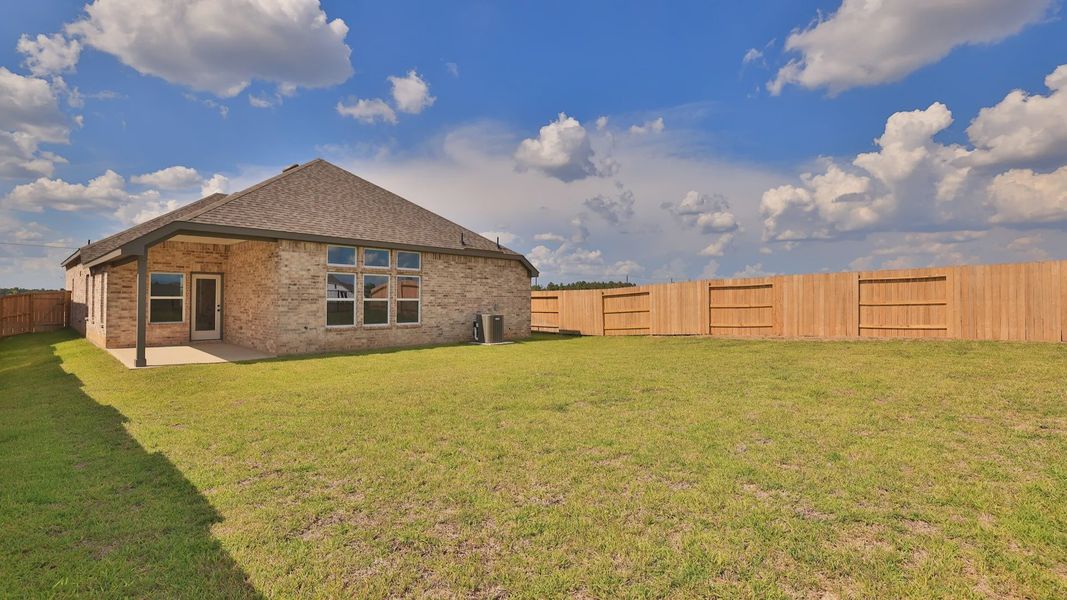 Exterior details and patio area of a home in Grand Magnolia, Magnolia (Image 21).