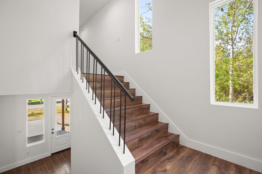 Stairway featuring wood finished floors and baseboards