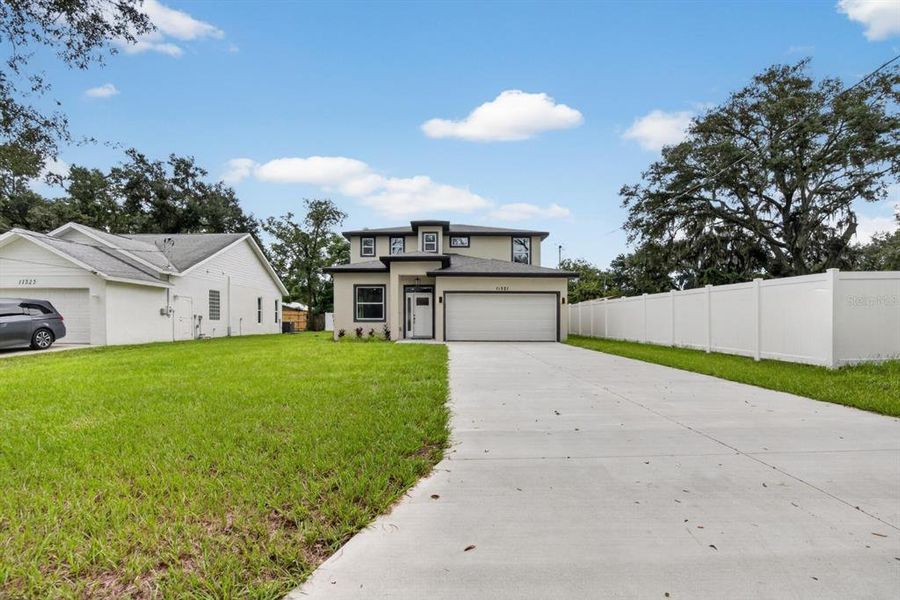 Front exterior of a new home in , Thonotosassa, FL, highlighting curb appeal (Image 1). Front exterior of a new home in , Thonotosassa, FL, highlighting curb appeal (Image 1).