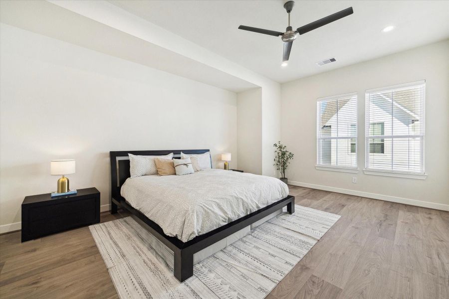 The spacious primary suite offers plenty of room for a full furniture set and relaxing natural light.