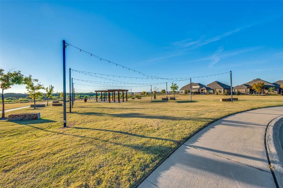 View of home's community with a yard