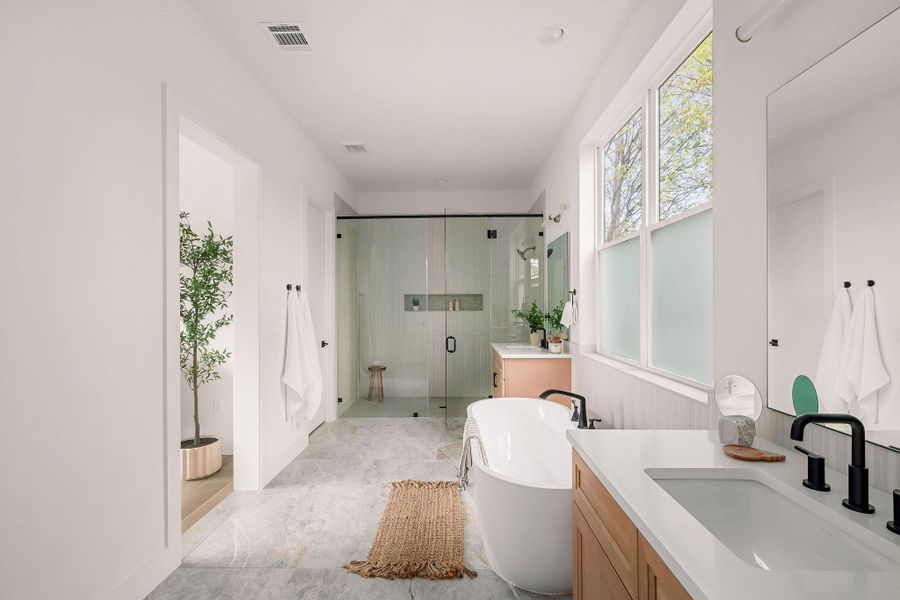 Bathroom featuring vanity, a freestanding tub, and a shower stall Bathroom featuring vanity, a freestanding tub, and a shower stall