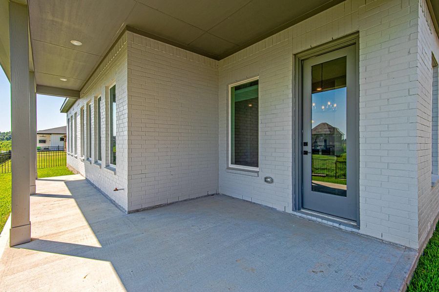 Covered back patio offering plenty of space for outdoor seating and entertaining