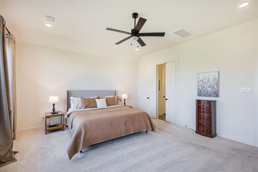 View of the primary bedroom and door to the extravagant primary bath.