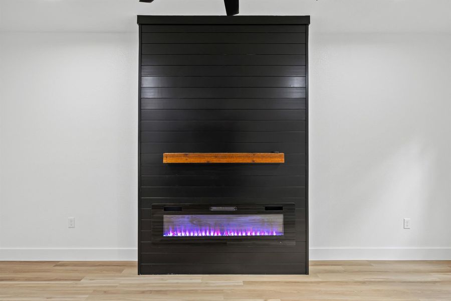 Detailed view of wood finished floors and a fireplace