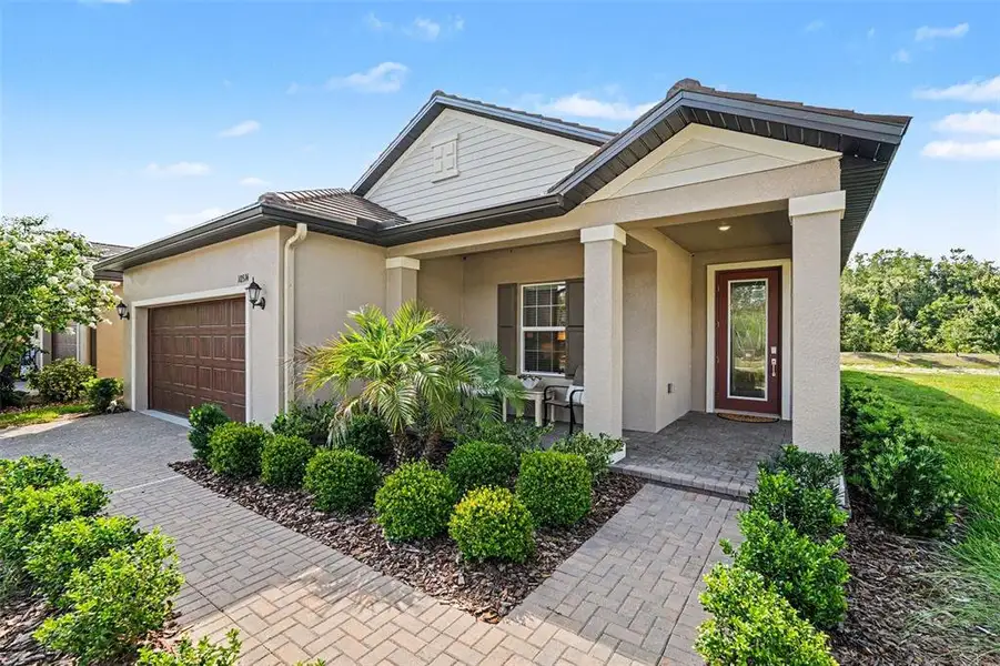 Front exterior of a new home in Angeline Active Adult, Land O' Lakes, FL, highlighting curb appeal (Image 21).