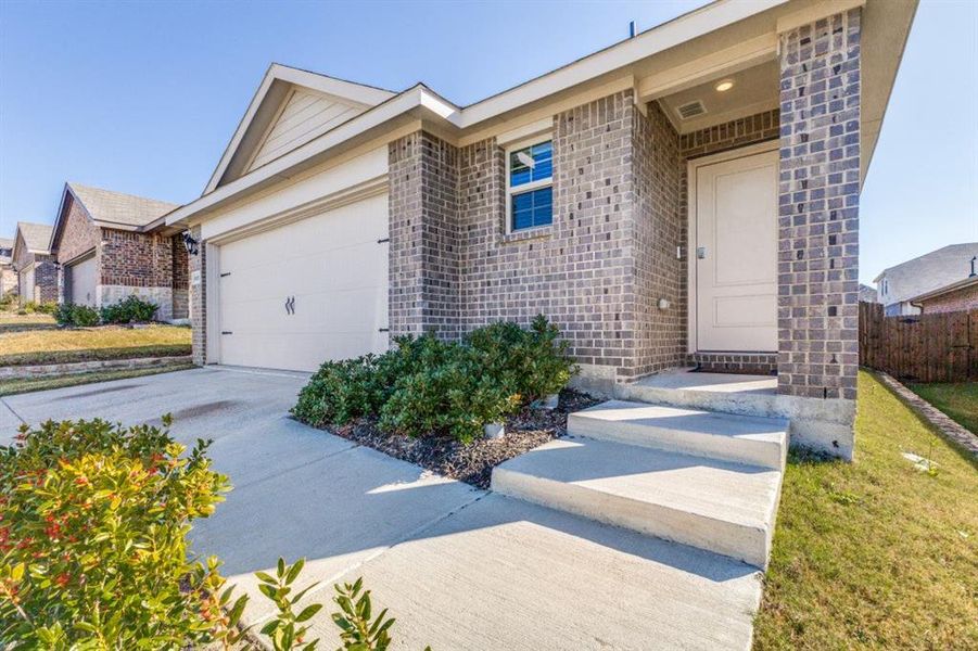 Ranch-style house with brick siding, driveway, and a garage Ranch-style house with brick siding, driveway, and a garage