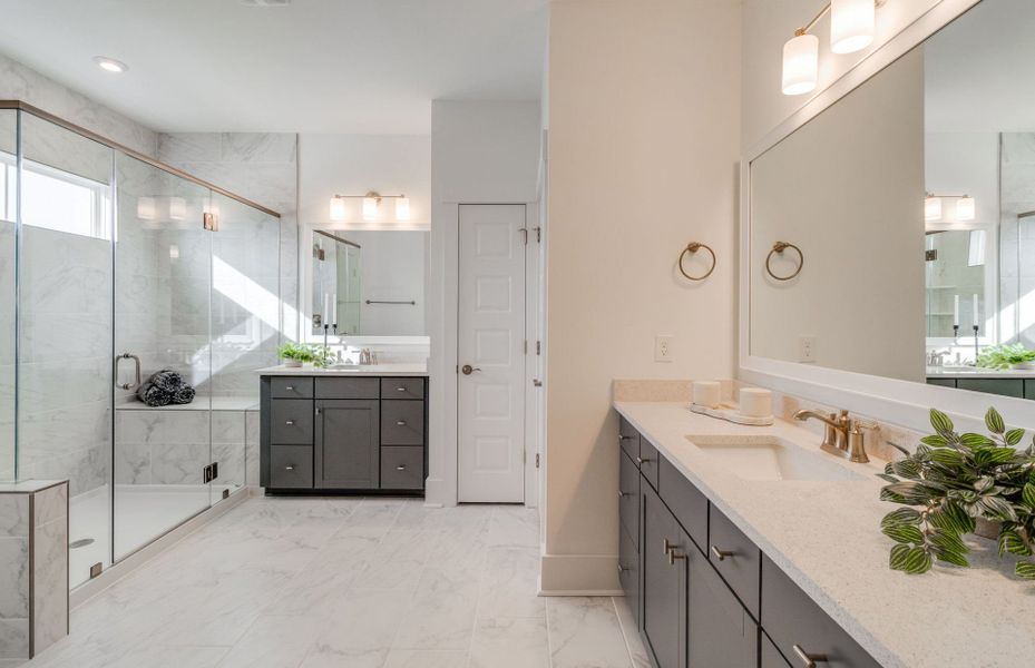 Owner's Bath with a large dual vanity, soaking tub, and a walk-in shower.