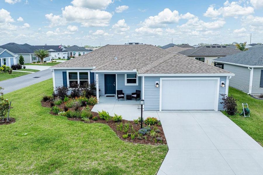 Front exterior of a new home in , The Villages, FL, highlighting curb appeal (Image 2).