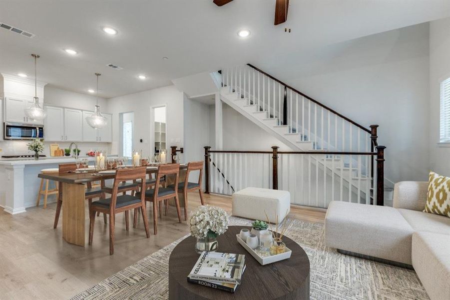 Living room with recessed lighting, visible vents, and light wood-style flooring