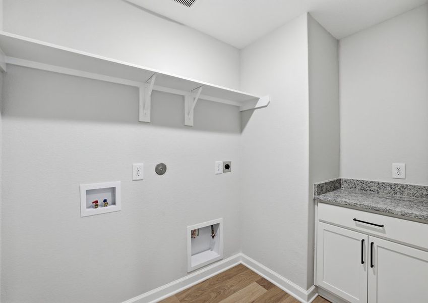 Second-floor laundry room featuring built-in shelving and a folding counter.