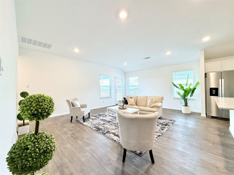 Living room featuring wood finished floors and recessed lighting Living room featuring wood finished floors and recessed lighting