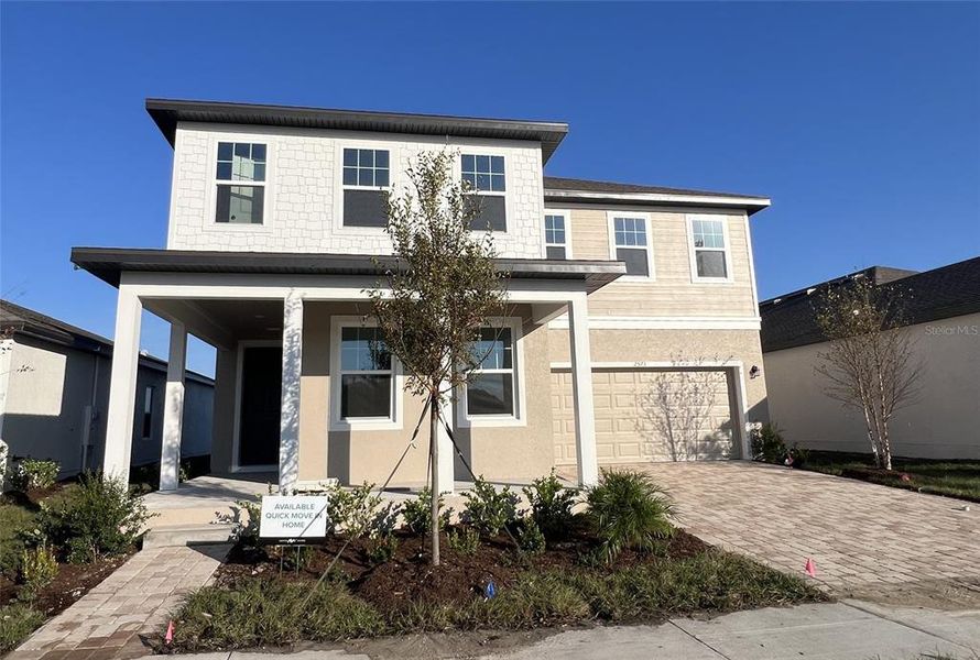 Front exterior of a new home in Hawks Run, Kissimmee, FL, highlighting curb appeal (Image 2). Front exterior of a new home in Hawks Run, Kissimmee, FL, highlighting curb appeal (Image 2).