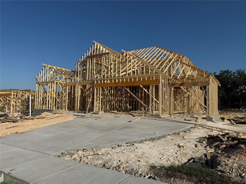 Front exterior of a new home in Lariat: 70ft. lots, Liberty Hill, TX, highlighting curb appeal (Image 20).