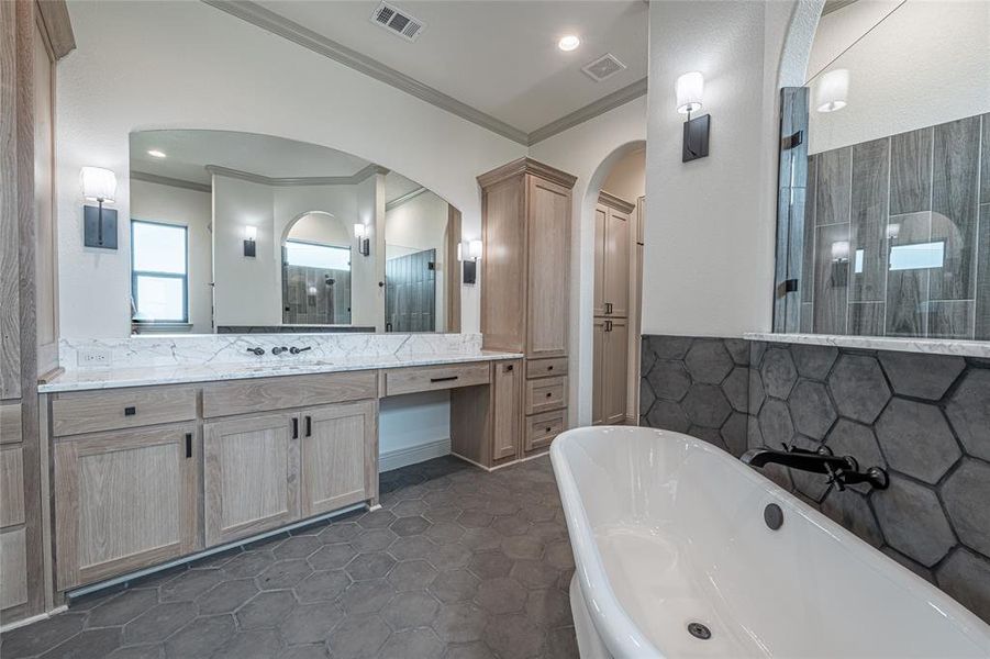 Bathroom with vanity, a soaking tub, ornamental molding, a tile shower, and recessed lighting Bathroom with vanity, a soaking tub, ornamental molding, a tile shower, and recessed lighting