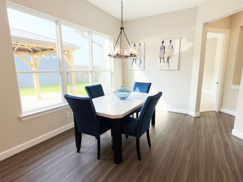 The dining room in the Portico at Winfrey Estates is an inviting, open space that seamlessly connects to the kitchen and private courtyard, perfect for both everyday meals and elegant entertaining. Image depicts home as-is virtually staged. The dining room in the Portico at Winfrey Estates is an inviting, open space that seamlessly connects to the kitchen and private courtyard, perfect for both everyday meals and elegant entertaining. Image depicts home as-is virtually staged.