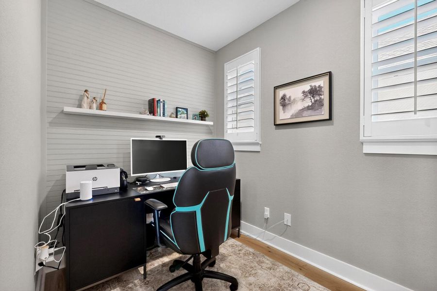 Office nook with baseboards and light wood-style floors