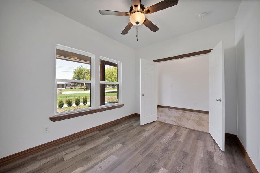 Unfurnished bedroom featuring wood finished floors and ceiling fan