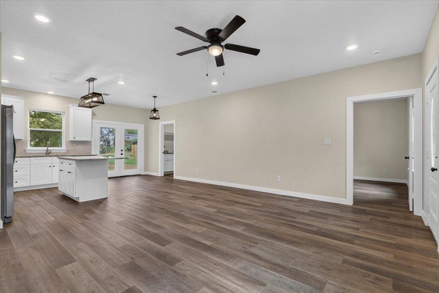 Gleaming wood-look floors anchor a versatile open-concept layout connecting the living area and kitchen. Gleaming wood-look floors anchor a versatile open-concept layout connecting the living area and kitchen.