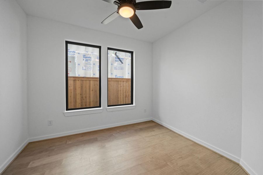 Positioned side by side, these double windows frame outdoor views beautifully while adding architectural balance and symmetry to the room.