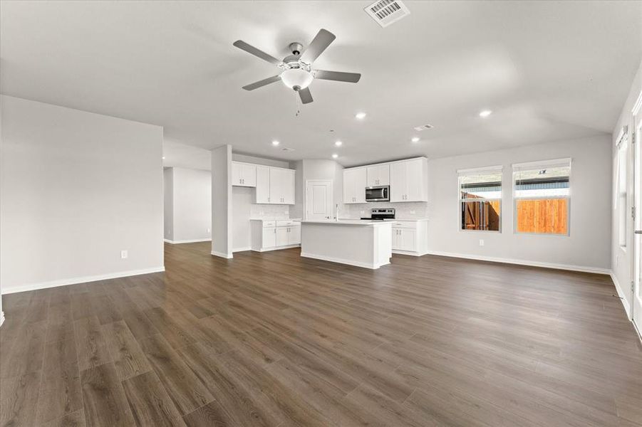 Expansive living room featuring ceiling fan and EVP flooring