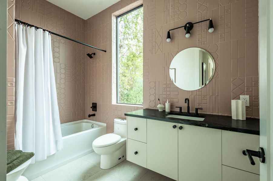 Who doesn't want to have a little fun in the guest bathroom. Gorgeous pink tile from Spain.