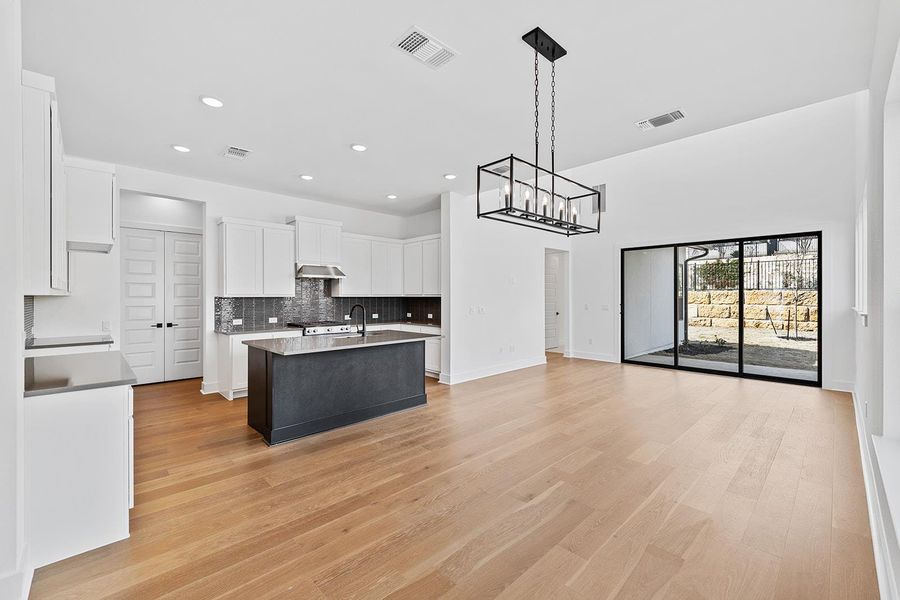 Open Floor plan to Dining area and family room with sliders to outdoor deck and yard