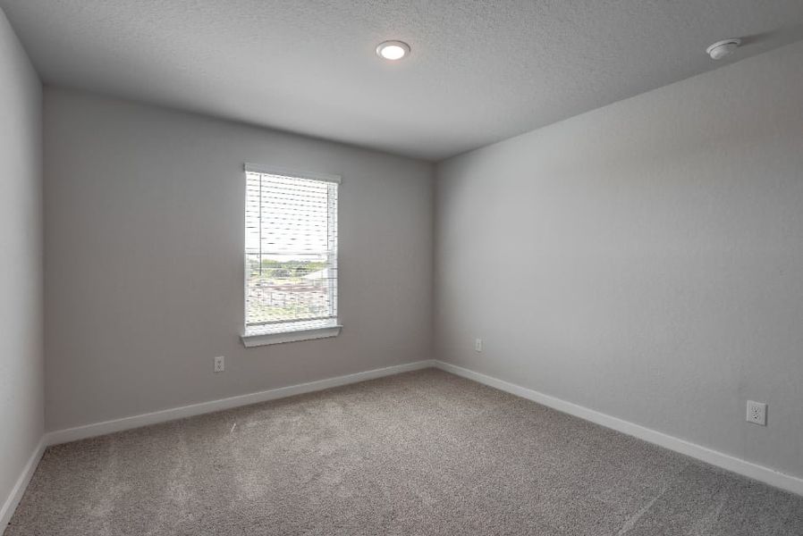 A room with a window and a carpet. A room with a window and a carpet.