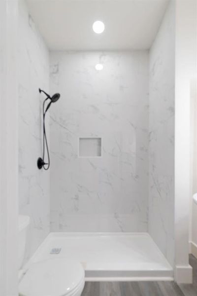 Full bath featuring a walk in shower, wood finished floors, and recessed lighting Full bath featuring a walk in shower, wood finished floors, and recessed lighting