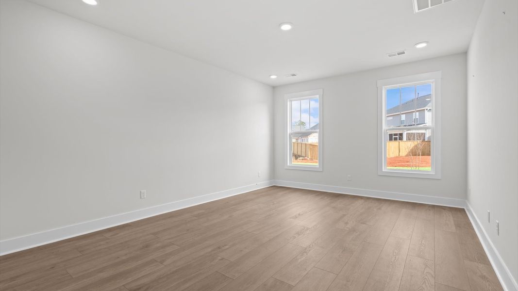 First-class hardwood floors and tasteful finishes elevate the private retreat of this exceptional primary suite