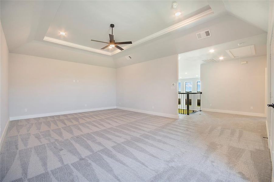 Unfurnished room with a raised ceiling, attic access, light colored carpet, recessed lighting, and crown molding Unfurnished room with a raised ceiling, attic access, light colored carpet, recessed lighting, and crown molding