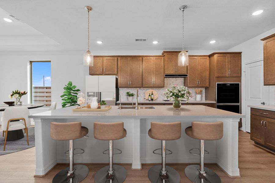 Kitchen featuring the AW Roosevelt Collection with traditional stained cabinetry, quartz countertops, and a tonal backsplash for a twist on old world charm..