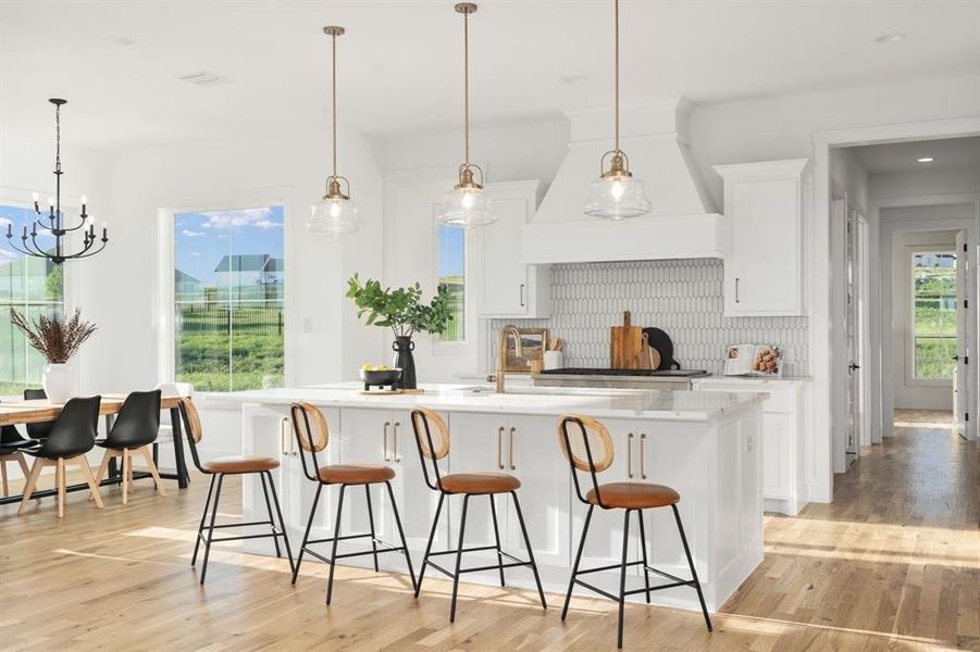 The breakfast nook is washed in beautiful light, and down the hall is the laundry space, mud area, and the master suite.