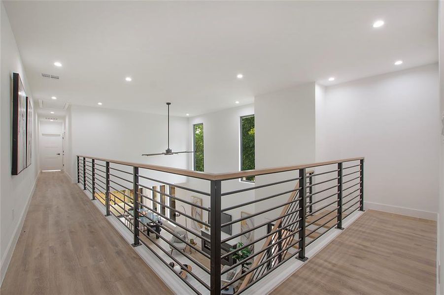 Hallway with light hardwood / wood-style flooring