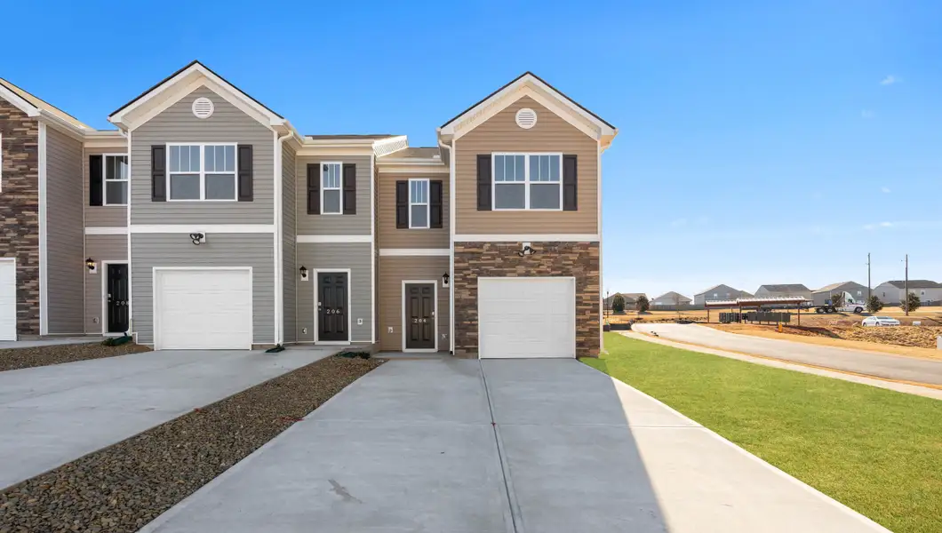 Front exterior of a new home in Covington Village, Greer, SC, highlighting curb appeal (Image 1).