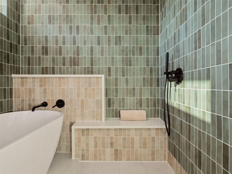 Full bathroom featuring tile walls, tile patterned flooring, and a freestanding tub