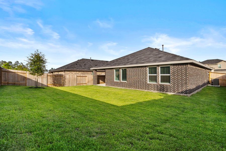 Exterior details and patio area of a home in Harrington Trails at The Canopies, Splendora (Image 16).