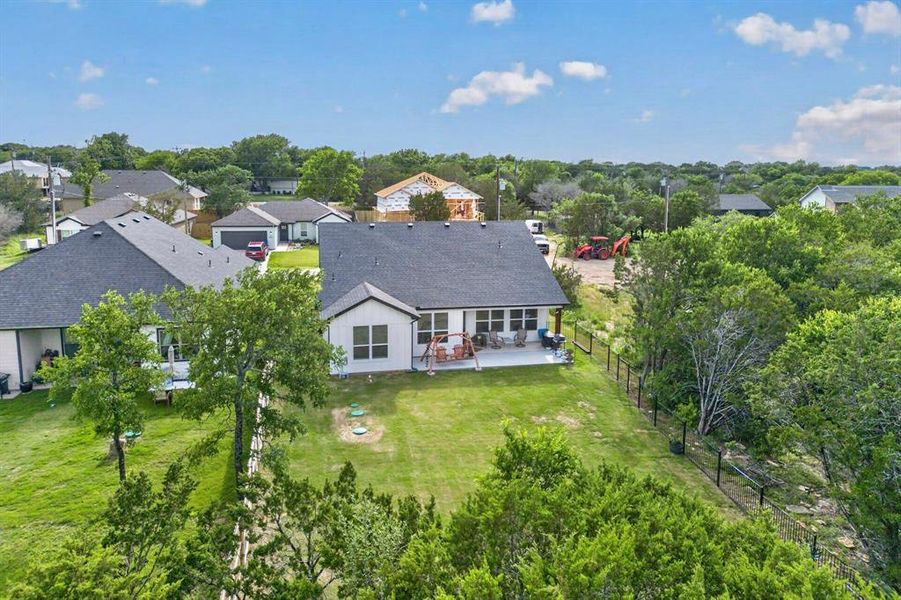 Contemporary single-story residence featuring a dark shingle roof and light-colored siding