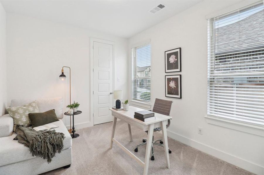 Carpeted office with baseboards, visible vents, and plenty of natural light Carpeted office with baseboards, visible vents, and plenty of natural light